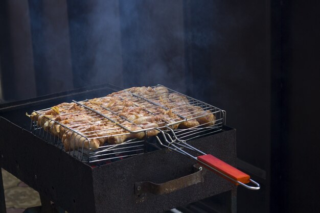 Cooking chicken legs in the grill summer vacation outdoor food