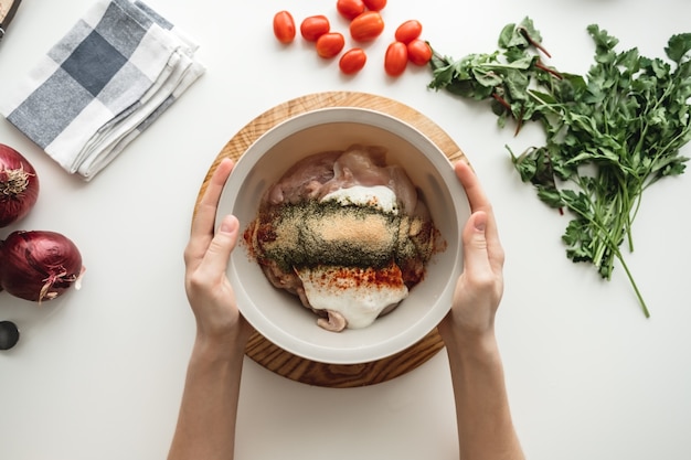 Cooking chicken roll with meat, fresh vegetables, herbs, and sauce