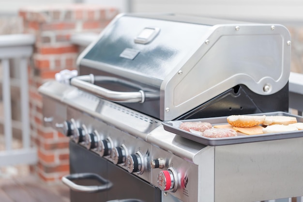 Cooking classic burgers on outdoor gas grill in the Summer.