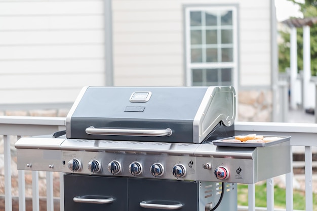 Cooking classic burgers on outdoor gas grill in the Summer.