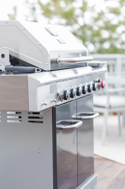 Cooking classic burgers on outdoor gas grill in the Summer.