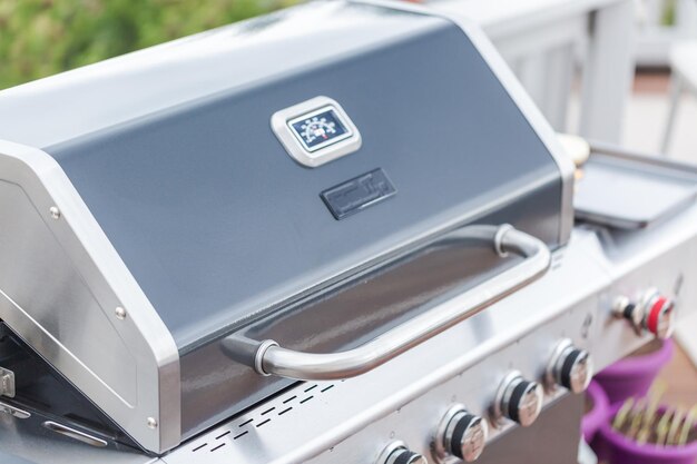 Cooking classic burgers on outdoor gas grill in the Summer.