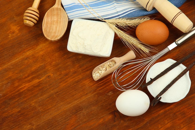 Cooking concept Basic baking ingredients and kitchen tools on wooden table