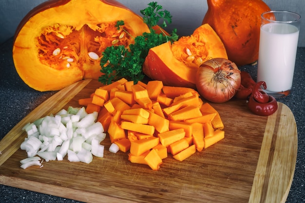 Cooking cream pumpking soup. Ingredients for pumpkin soup. Fresh herbs and vegetables. Healthy food. Selective focus.