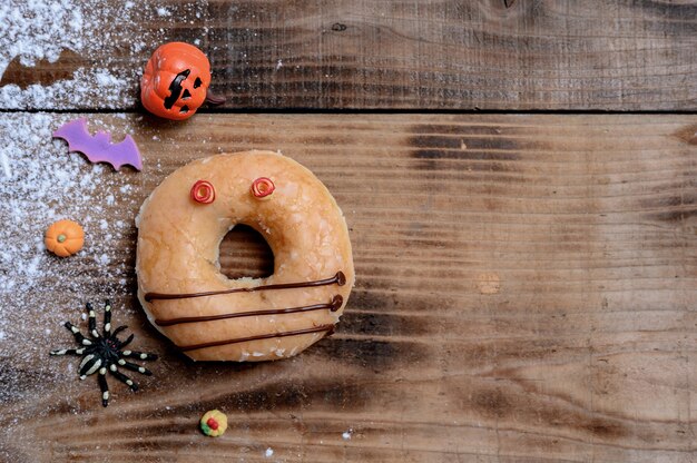 Cooking delicious homemade cake and decorate donut for Halloween festive. Sweet dessert and decoration for party at home.