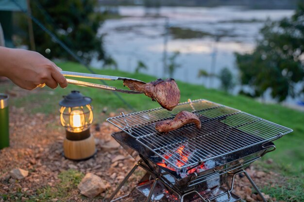 Cooking food during camping at natural park in Thailand. Recreation and journey outdoor activity lifestyle.