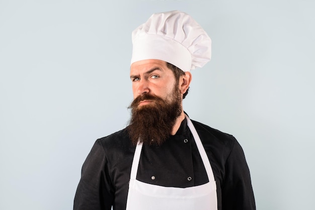 Cooking and food concept chief cook and professional culinary male chef food concept bearded chef in