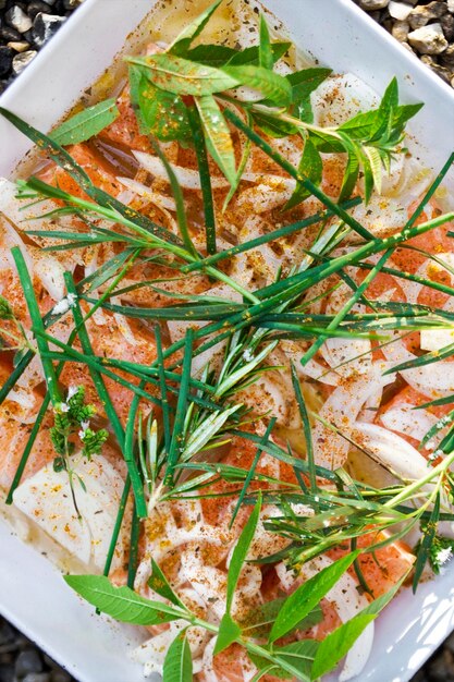 Cooking fresh salmon and herbs of the garden