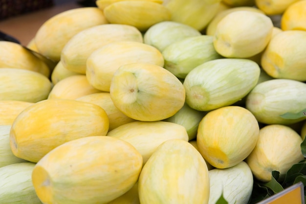 cooking, fruits, sale and food concept - peeled mango at street market