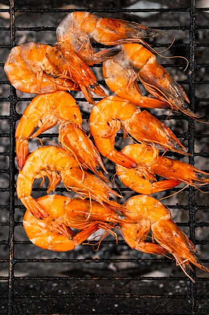 Cooking grilled prawns on barbecue BBQ shrimps close up