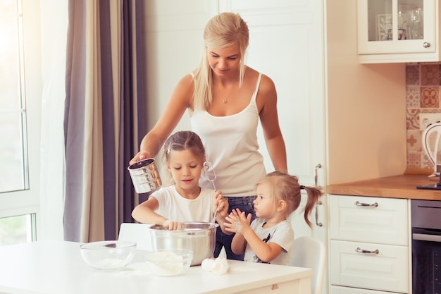 Cooking healthy food at home in the white kitchen Happy family in the kitchen