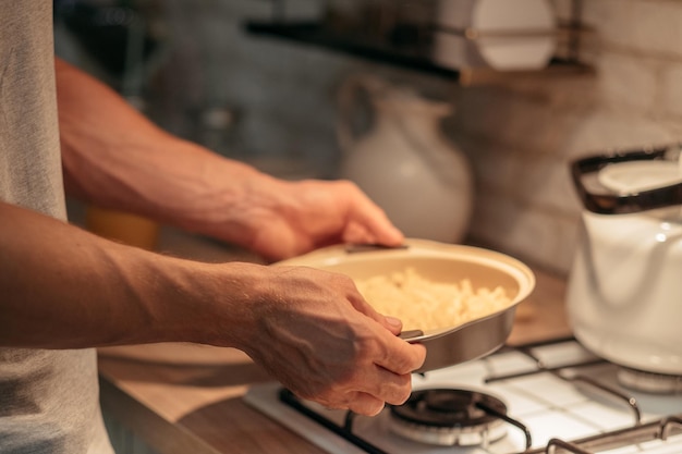 Cooking hobby and leisure Traditional culinary recipe Closeup of man hands holding frying pan with ready dinner meal