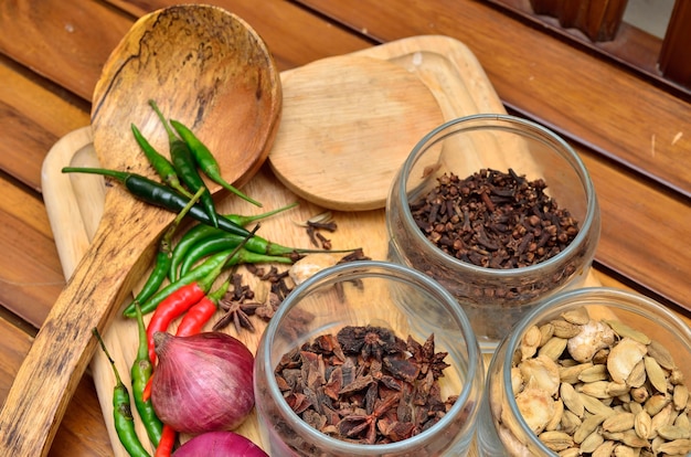 Cooking ingredients. Spice and herbs with onion and garlic on wooden board