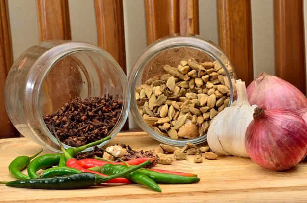 Cooking ingredients. Spice and herbs with onion and garlic on wooden board