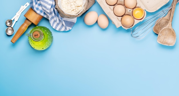 Cooking ingredients and utensils on blue background