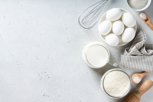 Cooking ingredients on a white table, view from above