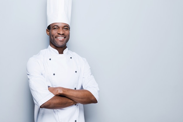 cooking is my passion. confident young african chef in white uniform keeping arms crossed 