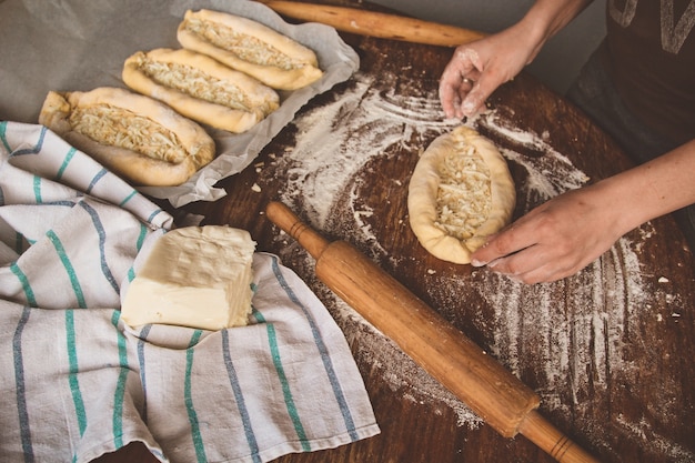 Cooking khachapuri with cheese on a table 