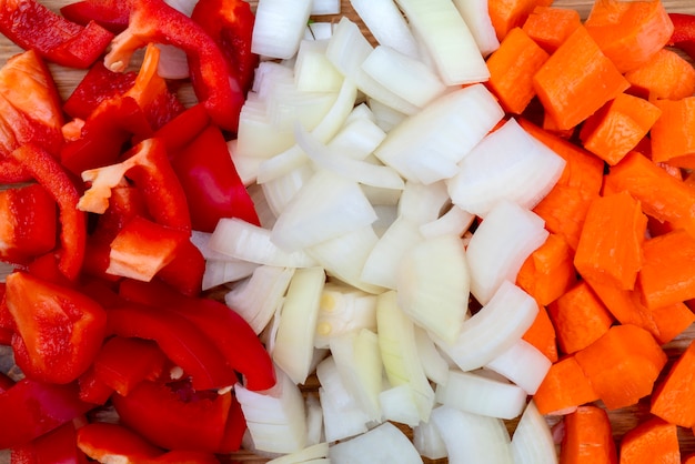 Cooking in the kitchen. Cut onions, carrots, sweet Bulgarian pepper. 