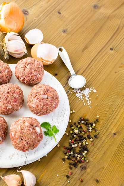 Cooking large homemade Italian meatballs for dinner.