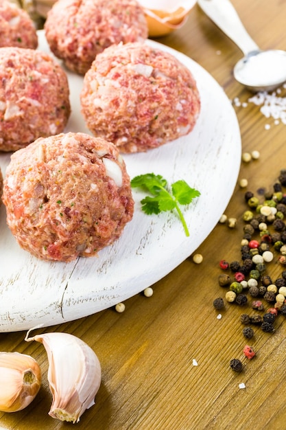 Cooking large homemade Italian meatballs for dinner.