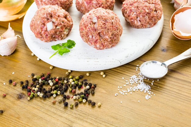 Cooking large homemade Italian meatballs for dinner.