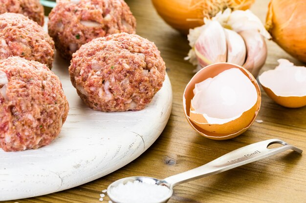 Cooking large homemade Italian meatballs for dinner.