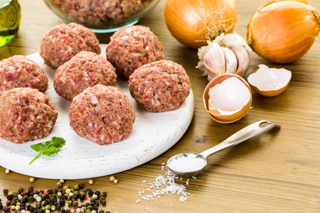 Cooking large homemade Italian meatballs for dinner.