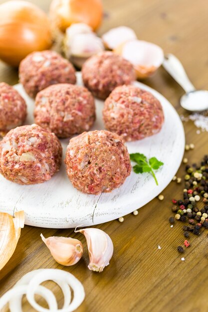 Cooking large homemade Italian meatballs for dinner.