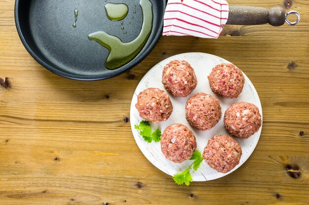 Cooking large homemade italian meatballs for dinner.