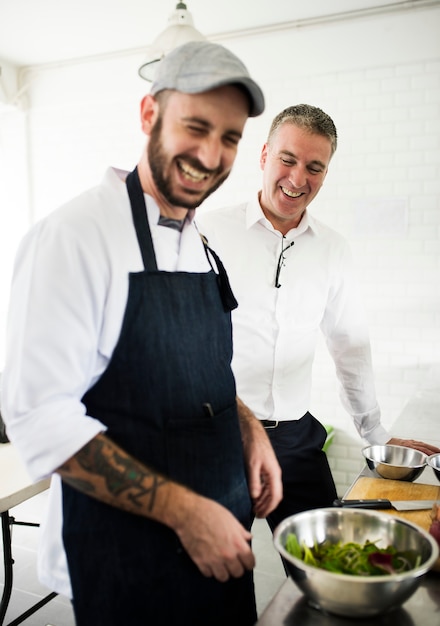 Cooking and a man talking in a kitchen