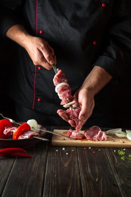 Cooking meat kebab with lamb in the kitchen of the restaurant by the hands of the chef