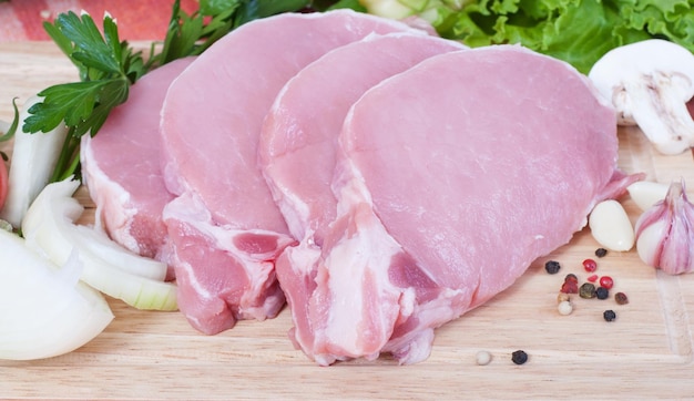 Cooking meat Pork with vegetables on wooden board