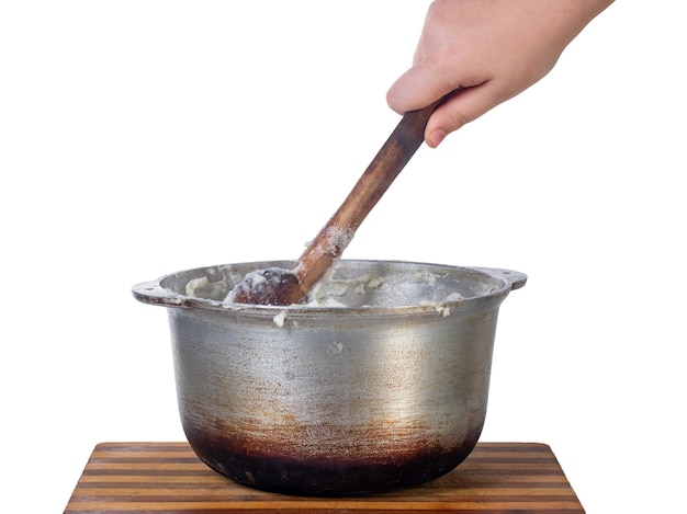 Cooking Mengrelian ghomi, mamalica in a metal bowl. Traditional Georgian food. White.