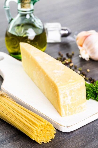 Cooking organic pasta with garlic herbs and parmesan cheese.