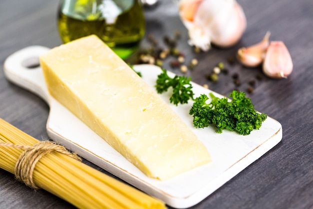 Cooking organic pasta with garlic herbs and parmesan cheese.