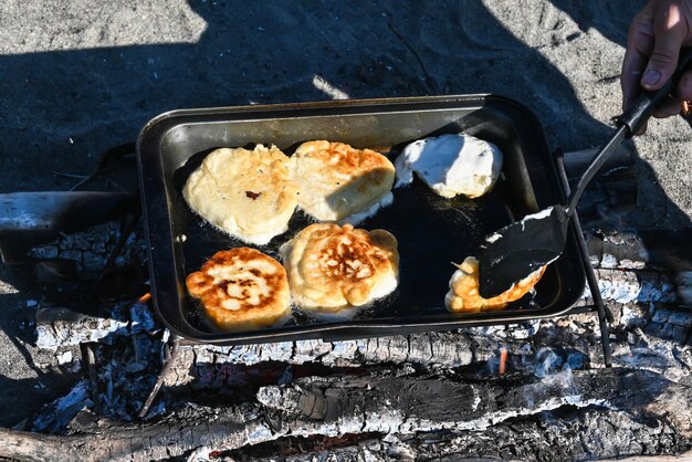 Cooking pancakes over the fire