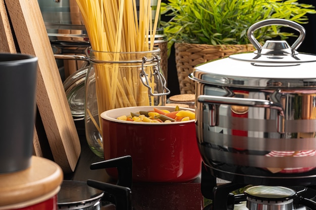 Cooking pasta at home kitchen in a pot close up