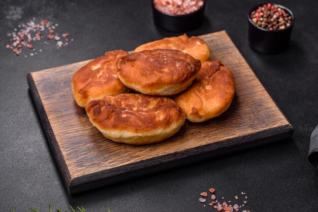 Cooking pies with potato on a wooden cutting board