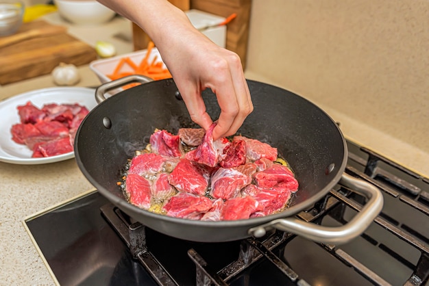 Cooking pilaf in a cauldron. A step by step recipe for cooking pilaf, cut the beef into pieces and fry in a cauldron, meat for pilaf.Cooking pilaf at home.