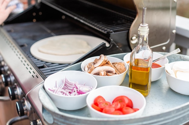 Cooking pizza on outdoor gas grill.