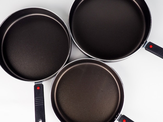 Cooking Pot and Frying Pans on White surface