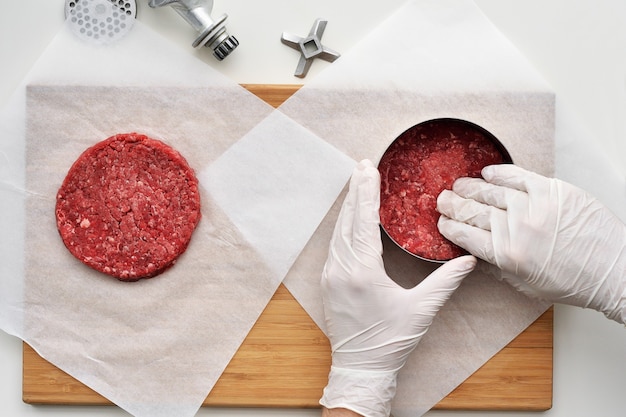 Photo cooking a prime black angus beef burger patties.