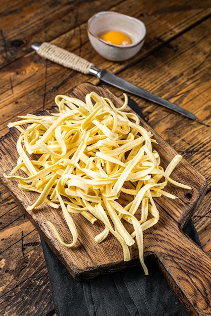 Cooking raw spaetzle egg noodle Wooden background Top view