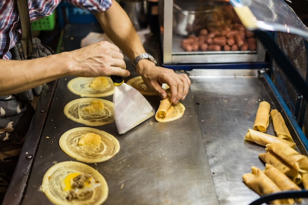 Cooking rolling pancake (Khanom Tokyo) thin flat pancake filled with sweet custard cream