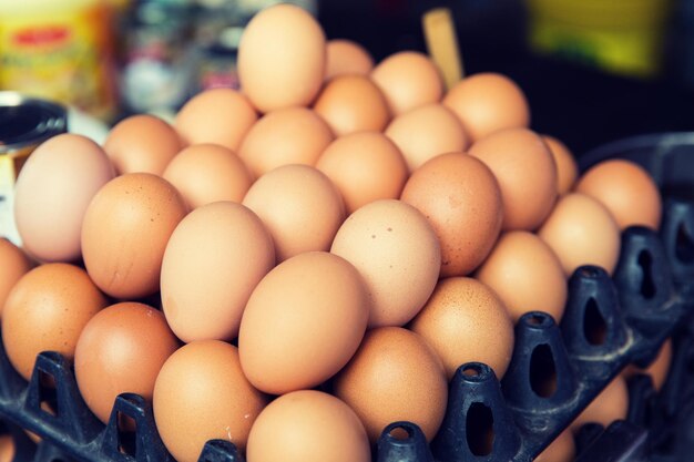 cooking, sale and food concept - fresh eggs on tray at asian street market