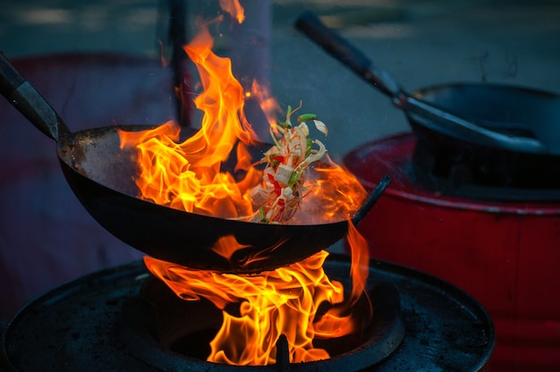 Cooking street food on a hot frying pan