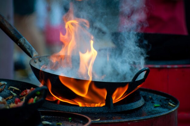 Cooking street food on a hot frying pan