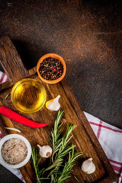 Cooking surface, herbs, salt, spices, olive oil, dark rusty surface