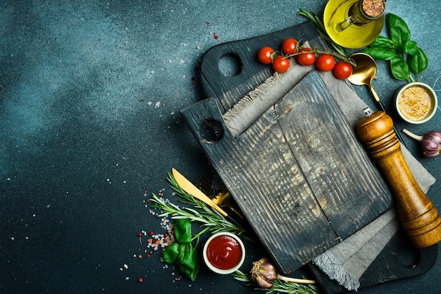 Cooking table with herbs spices and utensils Top view with copy space